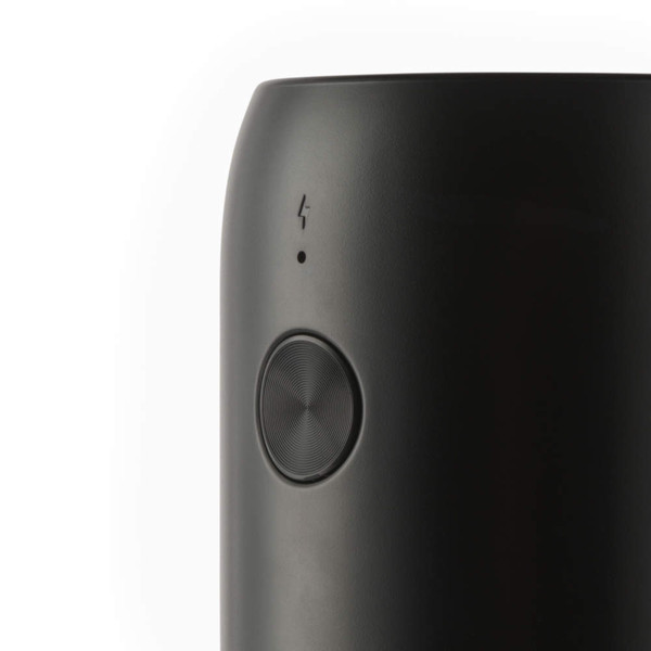 Black insulated travel mug showing side with button and charging symbol