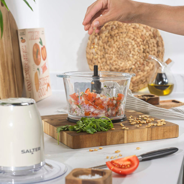 Cream electric food chopper with glass bowl, viewed from above