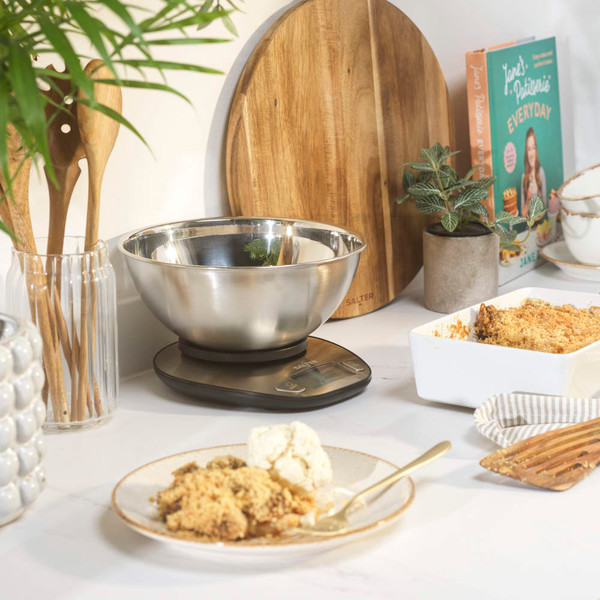 Digital kitchen scale with stainless steel bowl on worktop, suitable for baking or cooking