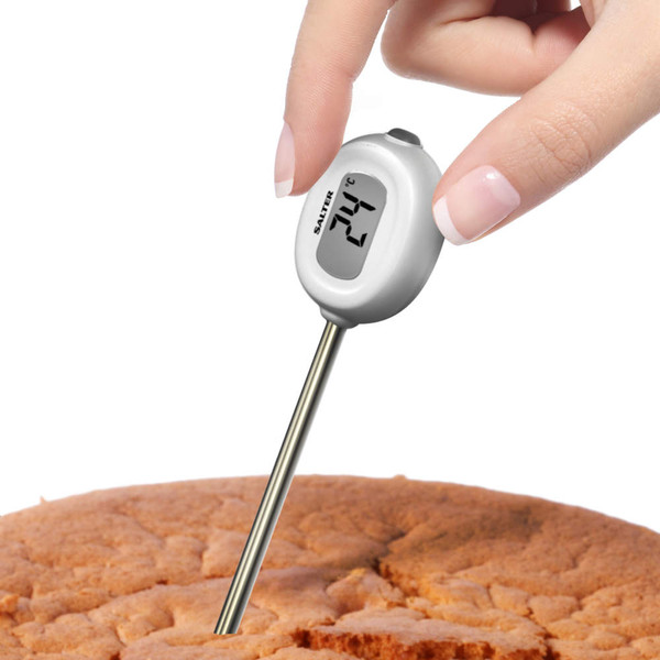 Digital cooking thermometer measuring cake temperature, display shows 24°C.