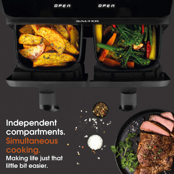 Salter air fryer with two open compartments, one with potato wedges and one with mixed vegetables.