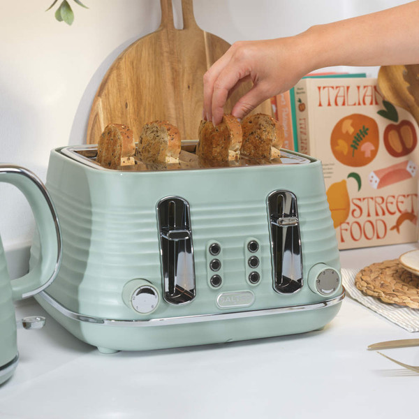 Sage green Salter kettle and four-slice toaster set with ribbed design, toaster loaded with bread slices