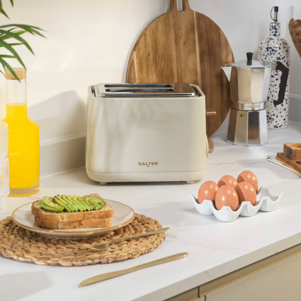 Stone-coloured 2-slice toaster on kitchen worktop, with eggs and avocado toast nearby