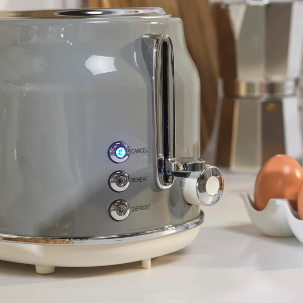 Grey two-slice toaster with cancel, reheat, and defrost buttons on kitchen counter