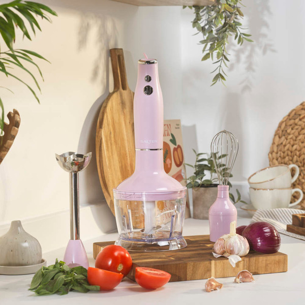 Pink hand blender set with chopper, whisk, and jug on kitchen counter