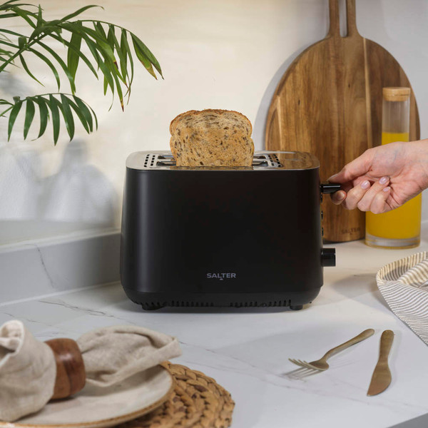 Black 2-slice toaster with sesame seed bagels toasting, angled product image