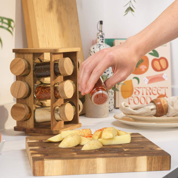 Empty glass spice jar with wooden lid and shaker top, lid shown beside jar