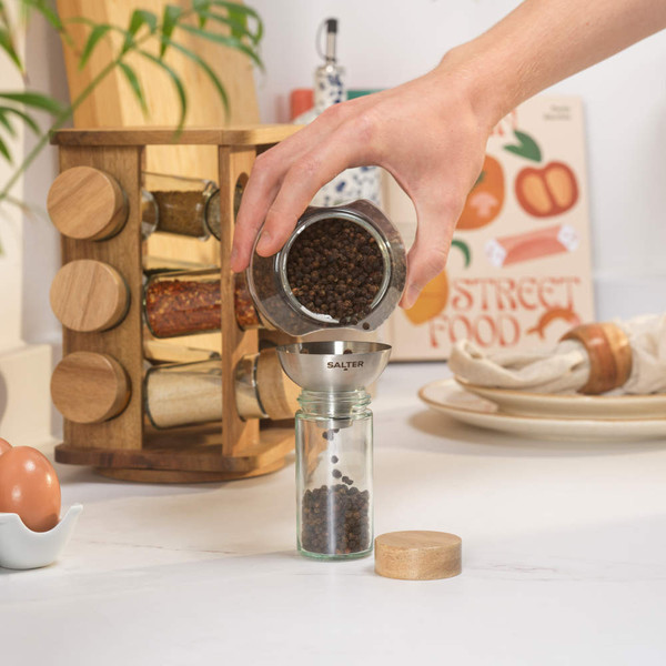 Empty glass spice jar with wooden lid and shaker top, lid shown beside jar