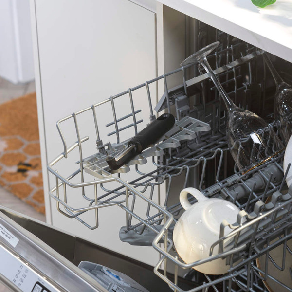 Open dishwasher rack with mugs and wine glasses inside