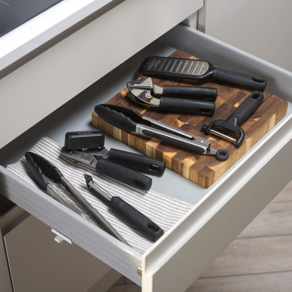 Manual can opener with black handles, angled view