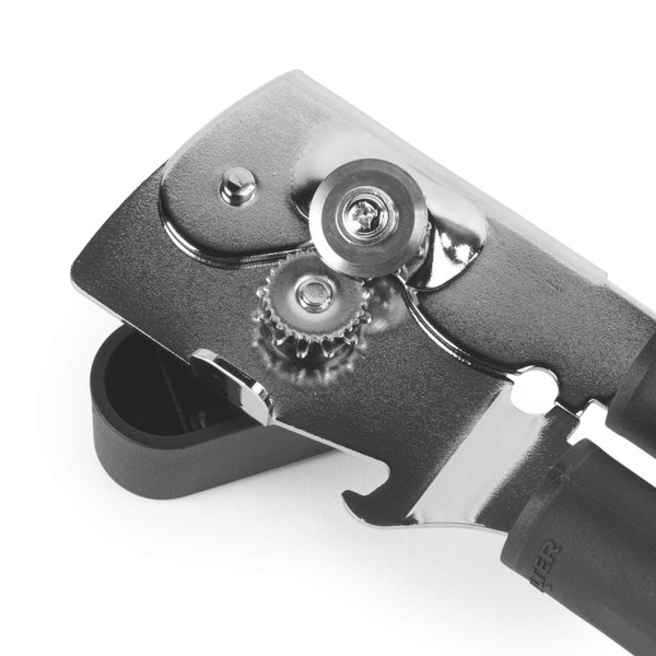Close-up of black and silver manual can opener showing cutting wheel