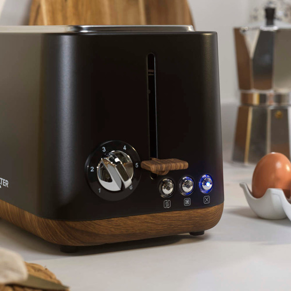 Black two-slice toaster with wood-effect trim and control dial on kitchen counter