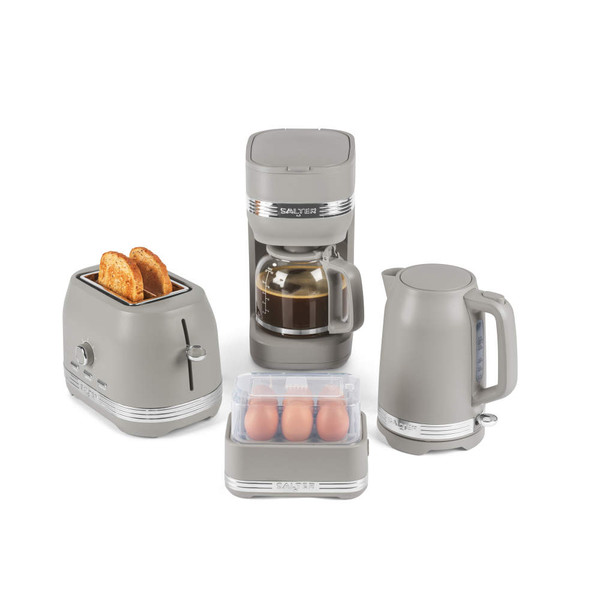 Taupe kettle and toaster set on kitchen counter with croissant and fruit breakfast.