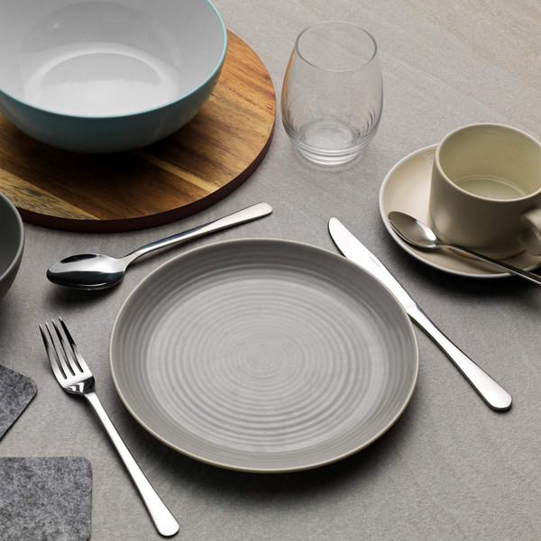 Grey ceramic dinner plate with cutlery, mug and bowl set on tabletop