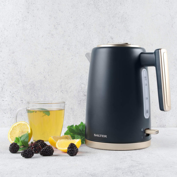 Dark grey Salter electric kettle with gold accents, shown with cup of tea, lemon, mint and blackberries.