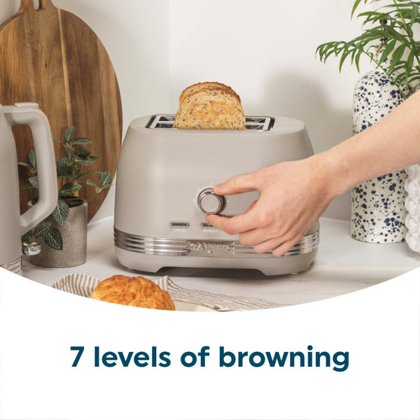 Taupe 4-slice toaster with slices of bread, shown on kitchen counter