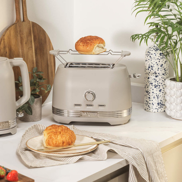 Taupe toaster with bun rack and kettle on kitchen worktop