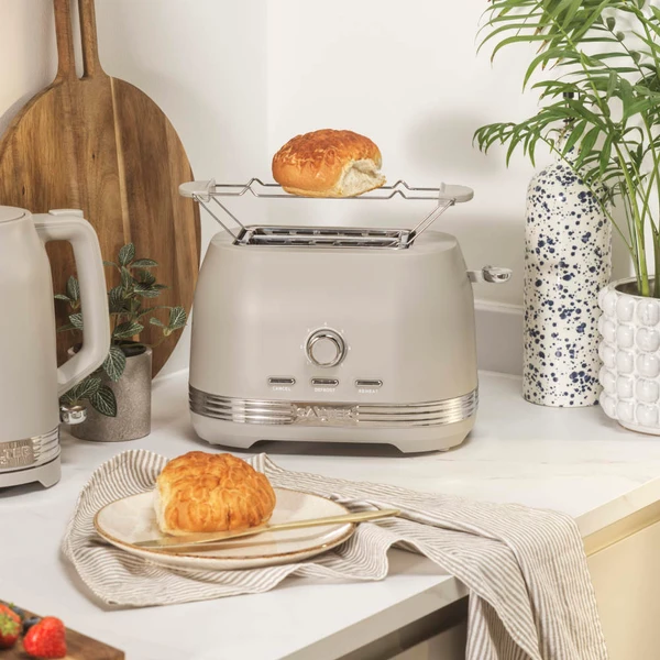 Taupe toaster with bun rack and kettle on kitchen worktop