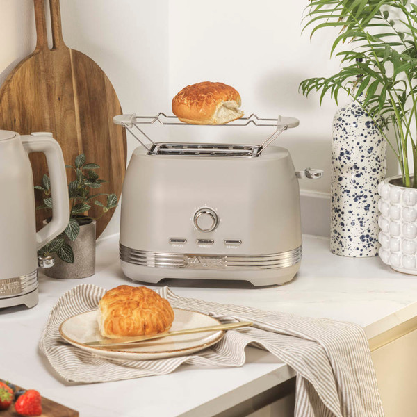 Taupe toaster with bun rack and kettle on kitchen worktop