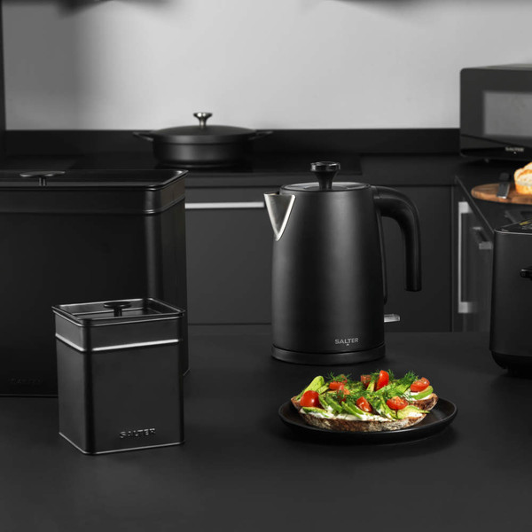 Matte black electric kettle on kitchen counter, part of Salter appliance set.