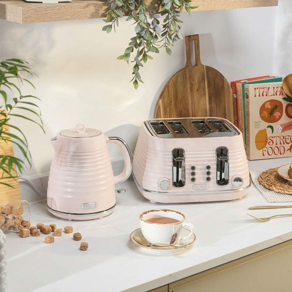 Pink kettle and four-slice toaster set on kitchen counter, styled for breakfast scene.