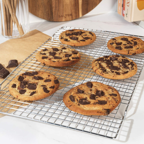 Silver metal cooling rack with raised legs, shown on white background.