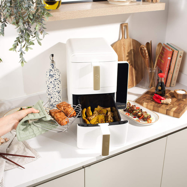 White dual drawer air fryer with digital touch controls and gold handles, shown empty