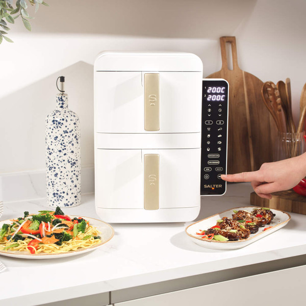 White and gold dual air fryer with digital display, showing cooked chicken in lower drawer