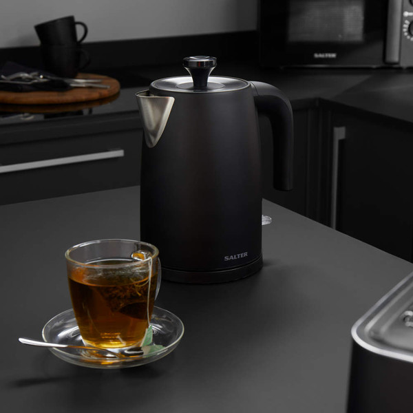 Black electric kettle with Salter branding on kitchen counter, side view