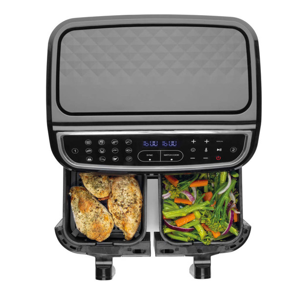 Black dual air fryer with chicken breasts and mixed vegetables in baskets, top-down view