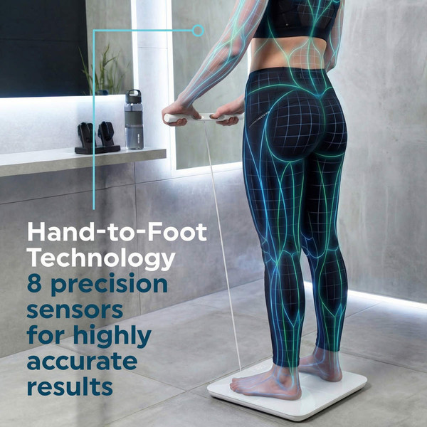 Person using digital bathroom scale with hand grips, highlighting sensor technology