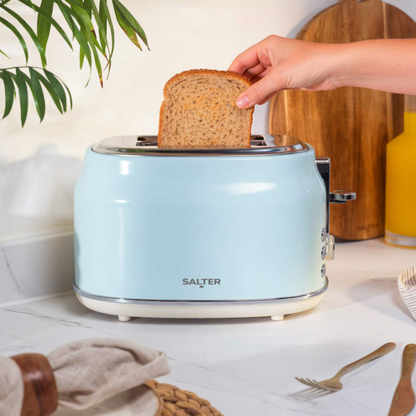 Close-up of light blue toaster with chrome reheat, defrost, cancel buttons and dial
