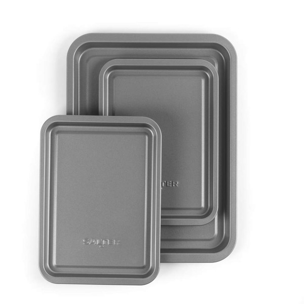 Set of three grey non-stick roasting trays, nested, viewed from above.