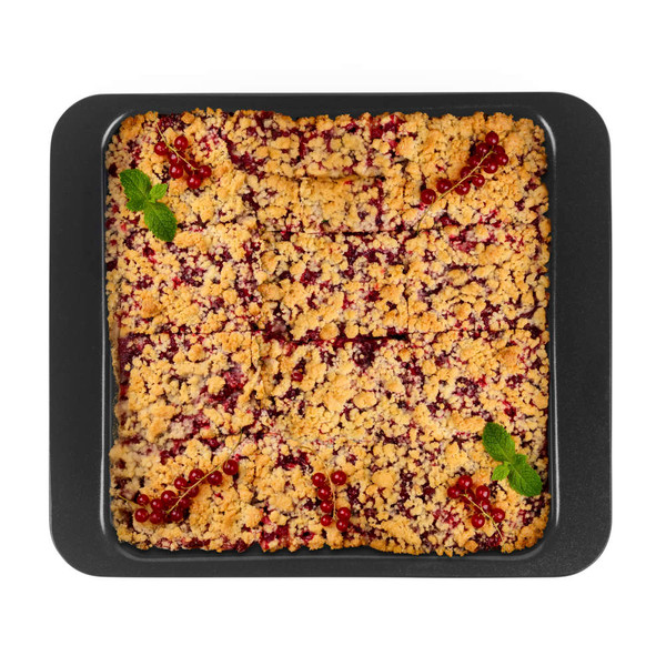 Tray of redcurrant crumble cake, cut into squares, topped with currants and mint.