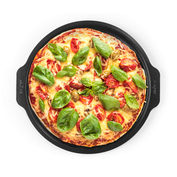 Vegetarian pizza with tomatoes, olives, cheese and fresh basil on a black baking tray
