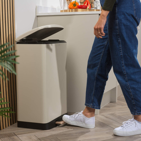 Cream pedal kitchen bin with open lid, shown in use