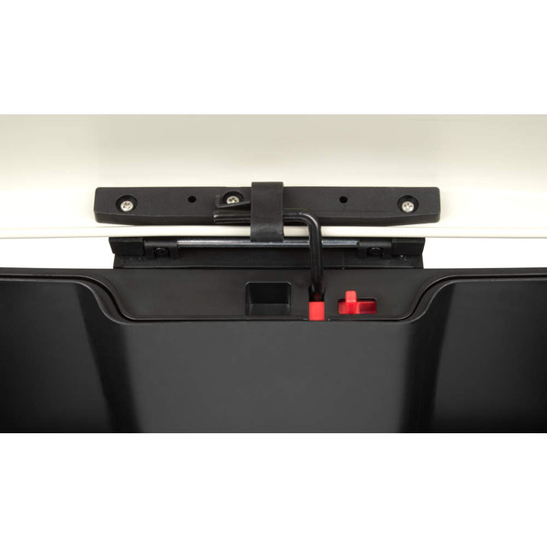 Close-up of black and cream pedal bin latch and locking mechanism with red release button