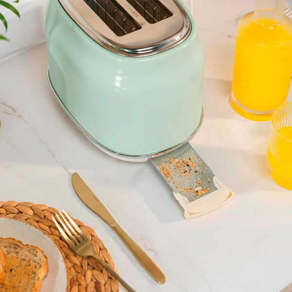 Green two-slot toaster with crumb tray open on kitchen worktop