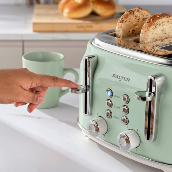 Mint green 4-slice toaster with bagels toasting, hand pressing lever