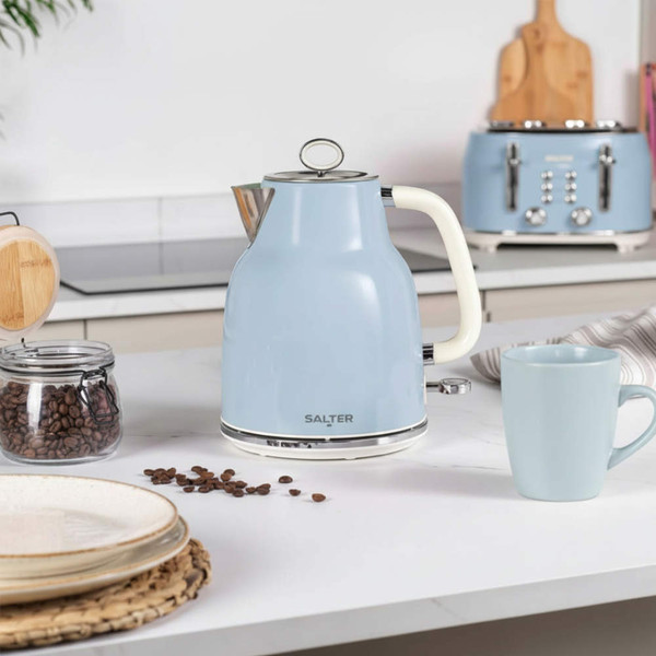 Light blue electric kettle with cream handle on kitchen counter