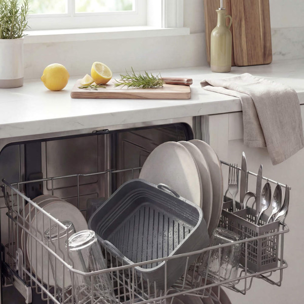 Grey roasting tray and plates in dishwasher, showing easy cleaning feature