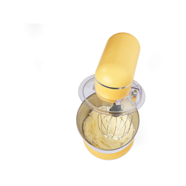 Yellow stand mixer with whisk attachment, mixing batter in stainless steel bowl