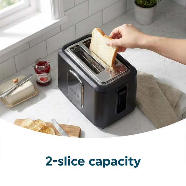 Black 2-slice toaster with bread being inserted