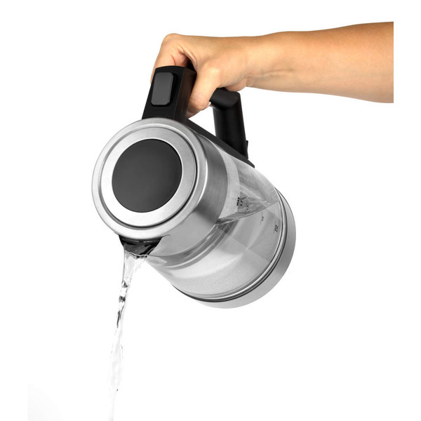 Glass electric kettle pouring water, close-up of hand holding black handle