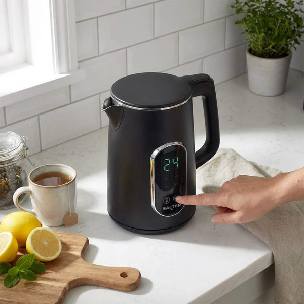 Black electric kettle with digital display, shown on kitchen worktop in use