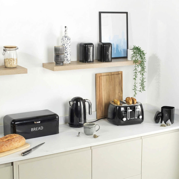 Black kettle and toaster set with bread bin on kitchen counter, UK breakfast scene