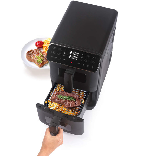 Black dual drawer air fryer on kitchen counter, fries and chicken visible inside