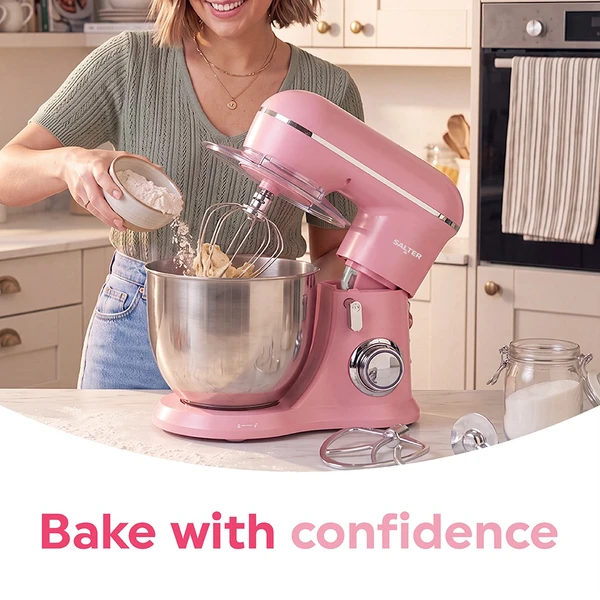 Pink stand mixer with stainless steel bowl on kitchen counter, shown in natural light