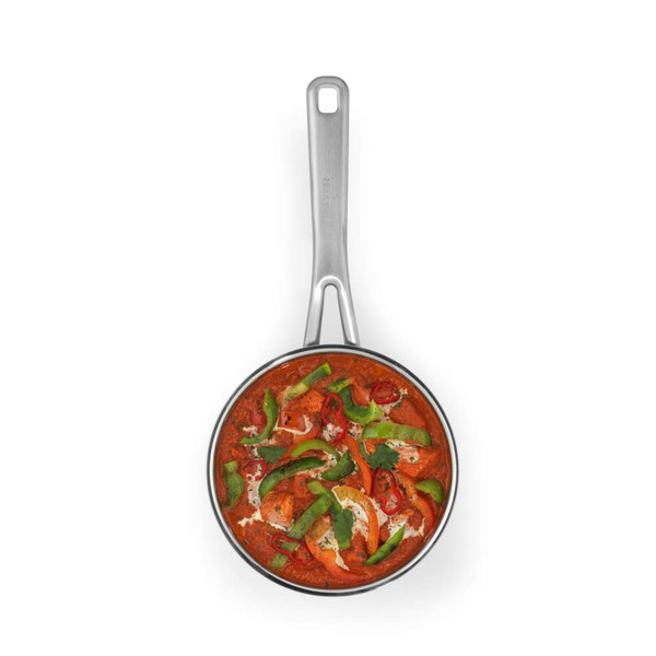 Stainless steel frying pan with handle, filled with red curry and mixed peppers, top view