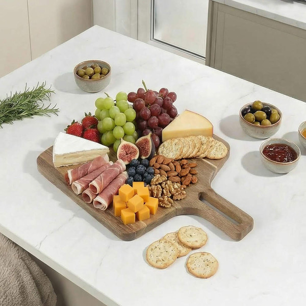 Charcuterie board with assorted cheeses, cured meats, fruit, nuts, and crackers.